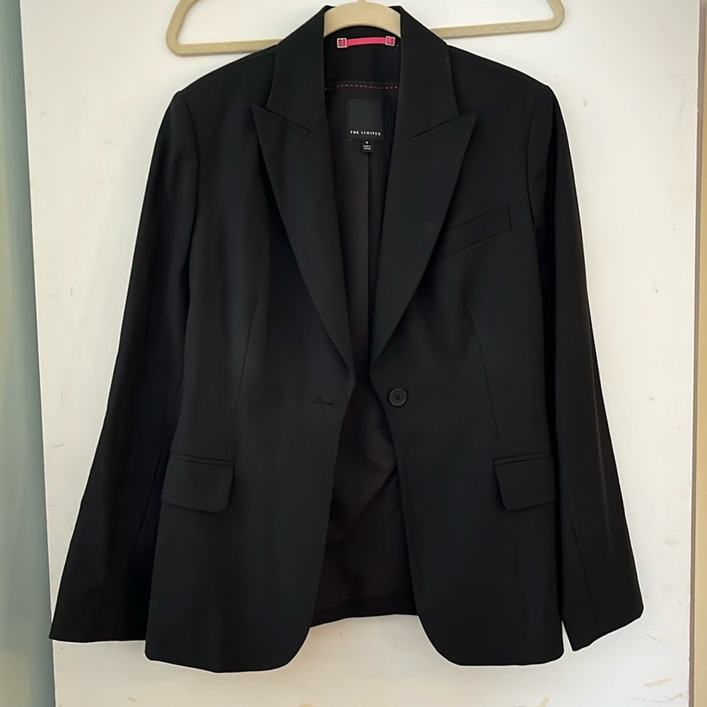 Timeless black blazer with a slightly nipped in waist that hugs curves